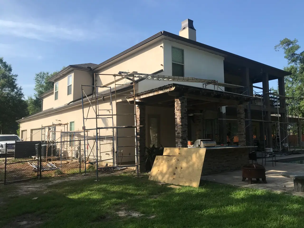 Two-story home with scaffolding up during an exterior stucco project